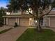 Evening view of townhome with well-maintained landscaping at 8362 Bella Tierra Ct, Davenport, FL 33896