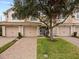 Townhome complex featuring brick driveways and lush landscaping at 8362 Bella Tierra Ct, Davenport, FL 33896