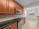 Kitchen boasts dark countertops, wood cabinets, and a breakfast nook at 8362 Bella Tierra Ct, Davenport, FL 33896