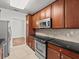 Well-equipped kitchen featuring wood cabinets and tile flooring at 8362 Bella Tierra Ct, Davenport, FL 33896