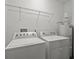 Laundry room with washer, dryer, and shelving at 8362 Bella Tierra Ct, Davenport, FL 33896