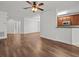 Open living space with hardwood floors and access to kitchen at 8362 Bella Tierra Ct, Davenport, FL 33896