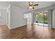Bright living room with wood floors and sliding glass doors at 8362 Bella Tierra Ct, Davenport, FL 33896