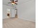 Carpeted main bedroom with ceiling fan and bathroom access at 8362 Bella Tierra Ct, Davenport, FL 33896