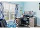 Home office with a corner desk, two monitors, and blue decor at 205 Bella Verano Way, Davenport, FL 33897