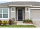 Black front door entry with landscaping and light fixtures at 205 Bella Verano Way, Davenport, FL 33897