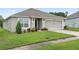 Single-story house with a two-car garage and well-maintained lawn at 205 Bella Verano Way, Davenport, FL 33897