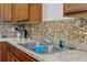 Clean kitchen sink with double basin and tile backsplash at 205 Bella Verano Way, Davenport, FL 33897