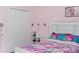 Bedroom with closet and colorful bedding at 205 Bella Verano Way, Davenport, FL 33897