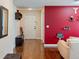 Bright entryway with wood floors and red accent wall at 205 Bella Verano Way, Davenport, FL 33897