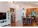 Open-concept kitchen with island, stainless steel appliances, and wood cabinets at 205 Bella Verano Way, Davenport, FL 33897