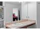 Bathroom vanity with sink and mirror reflecting bedroom at 205 Bella Verano Way, Davenport, FL 33897