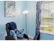 Relaxing sitting area with comfy chair and window view at 205 Bella Verano Way, Davenport, FL 33897