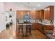 Open kitchen with island and wood cabinets at 205 Bella Verano Way, Davenport, FL 33897