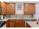 Modern kitchen with wood cabinets and tile backsplash at 205 Bella Verano Way, Davenport, FL 33897