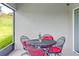 Small screened porch with metal table and chairs at 205 Bella Verano Way, Davenport, FL 33897