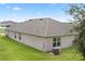 Rear view of house showcasing roofline and lawn at 205 Bella Verano Way, Davenport, FL 33897