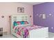 Bedroom with white bed frame and colorful bedding at 205 Bella Verano Way, Davenport, FL 33897