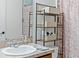 Bathroom with sink, storage shelving, and shower at 205 Bella Verano Way, Davenport, FL 33897
