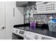 Bright laundry room with washer, dryer and shelving at 205 Bella Verano Way, Davenport, FL 33897