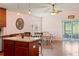 Kitchen with island, wood cabinets, and view to living area at 205 Bella Verano Way, Davenport, FL 33897