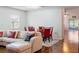 Open living room with light leather sectional and dining area at 205 Bella Verano Way, Davenport, FL 33897