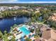Aerial view of community pool, clubhouse, and lake at 8298 Portofino Dr # 202, Davenport, FL 33896