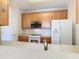 Kitchen with wood cabinets, granite countertops, and stainless steel appliances at 8298 Portofino Dr # 202, Davenport, FL 33896