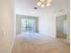 Bright living room with carpet, sliding doors, and balcony access at 8298 Portofino Dr # 202, Davenport, FL 33896