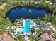 Bella Trae's refreshing pool and surrounding amenities, overlooking a serene lake at 8298 Portofino Dr # 202, Davenport, FL 33896