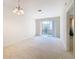 Living room with carpet flooring, sliding doors to balcony at 8298 Portofino Dr # 202, Davenport, FL 33896