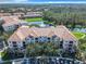 Drone view of condo building and parking lot at 8298 Portofino Dr # 202, Davenport, FL 33896