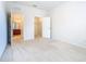 Simple bedroom with carpet flooring and access to a bathroom and closet at 8298 Portofino Dr # 202, Davenport, FL 33896