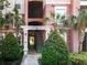 Condo building entrance with landscaping and stairs at 8298 Portofino Dr # 202, Davenport, FL 33896