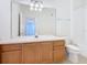 Bathroom with wood vanity, large mirror, and bathtub at 8298 Portofino Dr # 202, Davenport, FL 33896