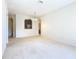 Bright dining room with neutral walls and carpet, and a view into the kitchen at 8298 Portofino Dr # 202, Davenport, FL 33896