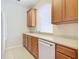 Kitchen boasts wood cabinets, white appliances, and granite countertops at 8298 Portofino Dr # 202, Davenport, FL 33896