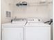 Bright laundry room with washer, dryer, and shelving at 8298 Portofino Dr # 202, Davenport, FL 33896