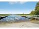 Calm lake with boat ramps and lush vegetation at 5562 Stockade Blvd, Saint Cloud, FL 34771