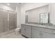 Bathroom with double vanity, granite countertop, and walk-in shower at 188 Bottle Brush, Haines City, FL 33844