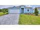 Light blue house with gray driveway and lawn at 188 Bottle Brush, Haines City, FL 33844