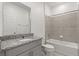 Bathroom with single vanity, granite countertop, and bathtub at 188 Bottle Brush, Haines City, FL 33844