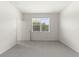 Bright bedroom with neutral carpeting and large window at 188 Bottle Brush, Haines City, FL 33844