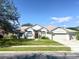 Two-story house with a red door and attached garage at 2656 Reagan Trl, Lake Mary, FL 32746