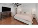 Main bedroom with king bed, dresser, and ceiling fan at 6341 Edge O Grove Cir, Orlando, FL 32819