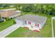 Aerial view of a single-story house with red shutters and a two-car garage at 319 St Cloud Rd, Poinciana, FL 34759
