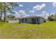 Spacious backyard with shed and grassy area at 319 St Cloud Rd, Poinciana, FL 34759