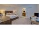 Main bedroom with a large bed, built-in desk, and en-suite bathroom at 319 St Cloud Rd, Poinciana, FL 34759