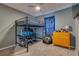 Bedroom with a loft bed, gaming setup, and dresser at 319 St Cloud Rd, Poinciana, FL 34759