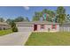 Gray house with red shutters, two-car garage, and well-maintained lawn at 319 St Cloud Rd, Poinciana, FL 34759